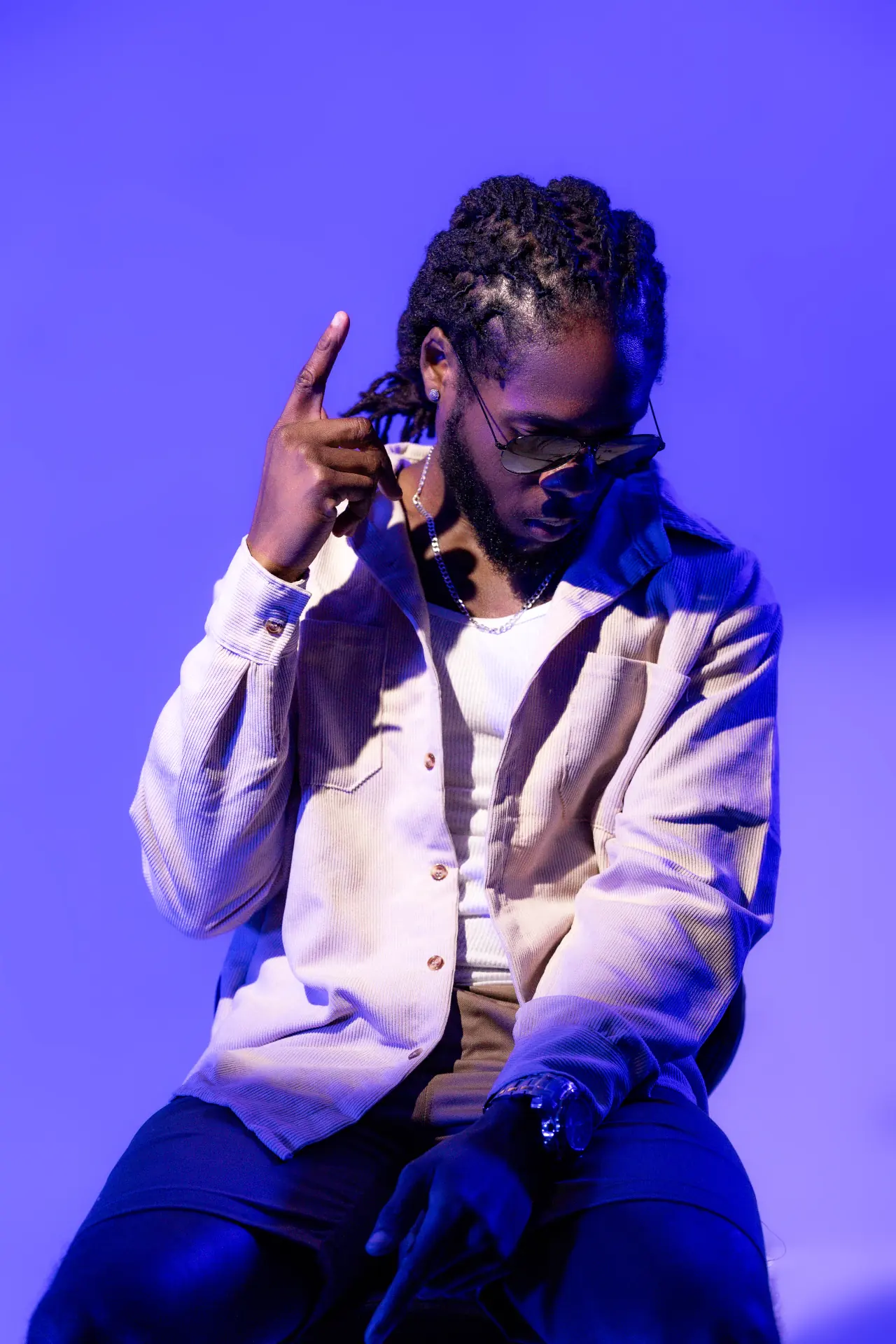 Saint Chris seated portrait in blue campaign lighting.